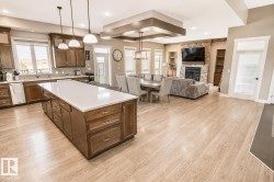 Expansive open-concept living space featuring wood-finish flooring - 