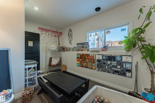 Interior room featuring wood-finish flooring, white walls, and a window with white trim - 4804 64 Avenue, Cold Lake, AB 