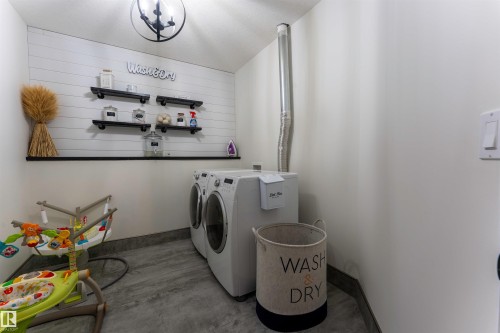 Dedicated laundry area featuring a front-loading washer and dryer set - 4804 64 Avenue, Cold Lake, AB 