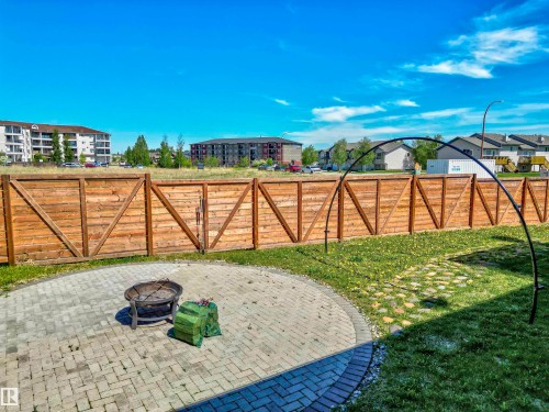 Spacious backyard featuring a semicircular paver patio and a wood privacy fence - 4804 64 Avenue, Cold Lake, AB 