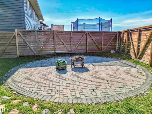 Circular paver patio with a herringbone pattern and contrasting border - 4804 64 Avenue, Cold Lake, AB 