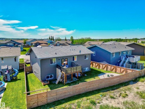 Contemporary two-story residence featuring dark gray siding and a light gray shingle roof - 4804 64 Avenue, Cold Lake, AB 