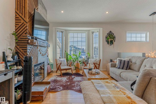 Living area featuring hardwood-finish flooring and a bay window - 4804 64 Avenue, Cold Lake, AB 