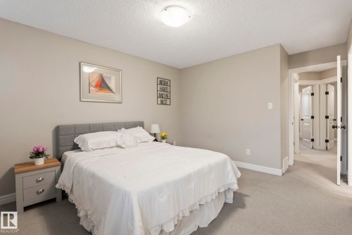 Carpeted bedroom with a neutral color palette - 1542 33A St Nw, Edmonton, AB 
