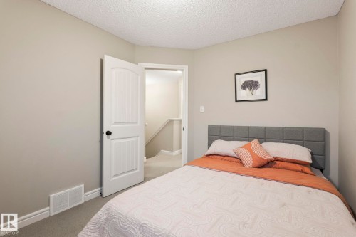 Neutral wall tones complement the textured ceiling - 1542 33A St Nw, Edmonton, AB 