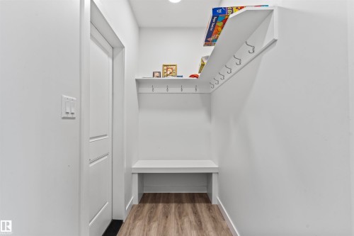 Built-in entryway bench with storage, upper shelving, and integrated hanging hooks - 8046 Kiriak Link, Edmonton, AB - Indoor With Storage