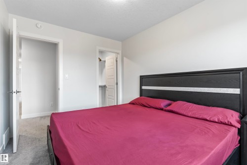 Neutral-toned bedroom featuring carpet flooring and white trim - 8046 Kiriak Link, Edmonton, AB - Indoor Photo Showing Bedroom