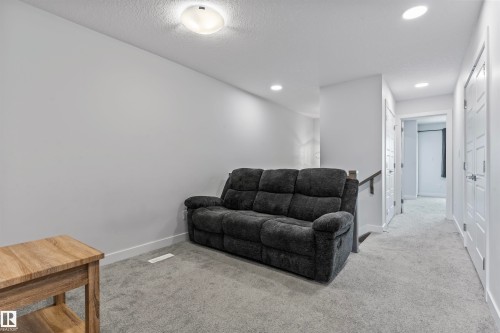 Upper-level bonus room featuring plush grey carpeting, recessed lighting, and a neutral wall palette - 8046 Kiriak Link, Edmonton, AB - Indoor