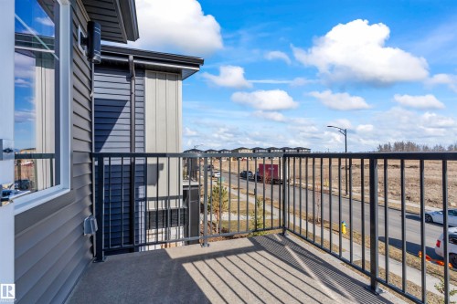 Private concrete balcony with black metal railing - 8046 Kiriak Link, Edmonton, AB - Outdoor With Balcony