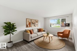 Living area with light wood-finish flooring and white wall finishes - 