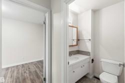 Bathroom with white vanity, integrated sink, and wood-framed medicine cabinet - 