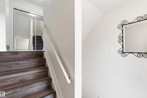 Staircase with wood-finish treads and white risers - 3312 106 Avenue, Edmonton, AB 