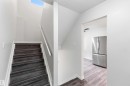 Modern staircase with dark wood-finish treads and white risers - 3312 106 Avenue, Edmonton, AB 
