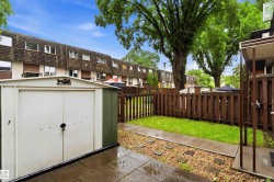 Private fenced yard featuring a storage shed - 