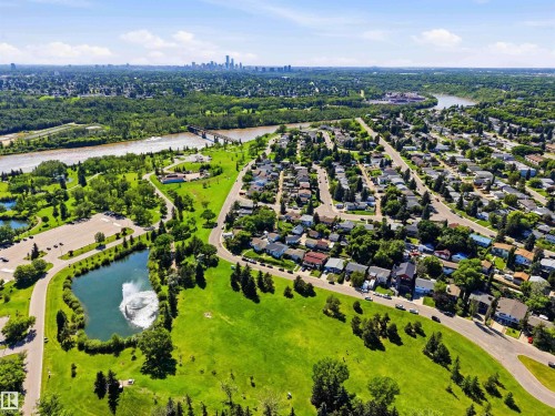 Expansive aerial landscape highlighting a residential area with a river, bridge, and distant city skyline - 3312 106 Avenue, Edmonton, AB 
