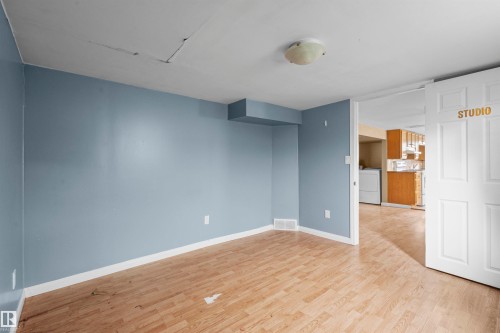 Light blue painted walls with white trim and wood-finish flooring - 7520 106 Street, Edmonton, AB 