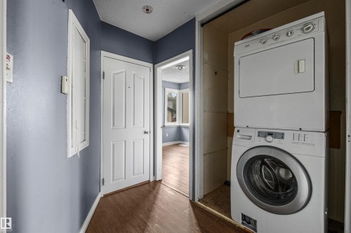 Dedicated laundry area featuring a stacked washer and dryer - 7520 106 Street, Edmonton, AB 