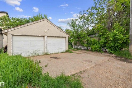 Detached two-car garage with white garage doors and a stucco exterior - 7520 106 Street, Edmonton, AB 
