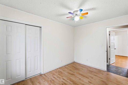 Light wood-finish flooring complements the neutral wall color - 17303 107 Street, Edmonton, AB 
