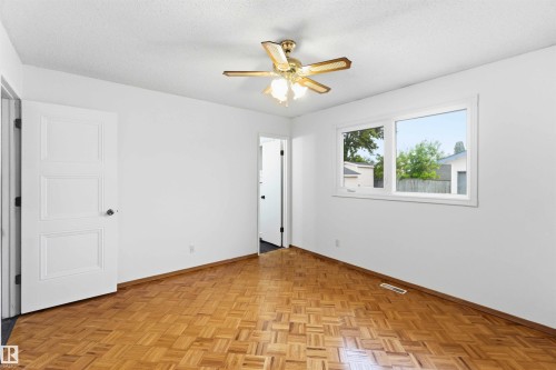 Bright interior space featuring parquet wood-finish flooring - 17303 107 Street, Edmonton, AB 