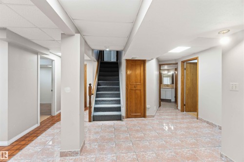 Expansive lower level featuring neutral wall tones, recessed lighting, and a combination of ceramic tile and wood-finish flooring - 17303 107 Street, Edmonton, AB 