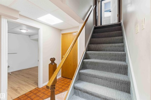 Carpeted staircase with wooden handrail - 17303 107 Street, Edmonton, AB 