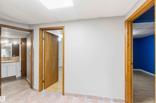 Interior hallway featuring light-toned walls and floor tiles - 17303 107 Street, Edmonton, AB 