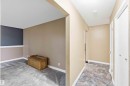 Carpeted room with a two-tone accent wall and white baseboards - 17303 107 Street, Edmonton, AB 