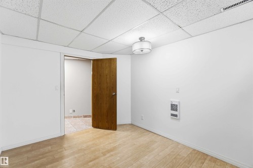 Interior room featuring light wood-finish flooring and white painted walls - 17303 107 Street, Edmonton, AB 