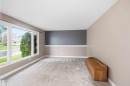Spacious room featuring light-colored carpeting and a large multi-pane window - 17303 107 Street, Edmonton, AB 