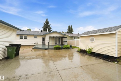 Expansive concrete patio providing access to the rear deck and a separate storage shed - 17303 107 Street, Edmonton, AB 