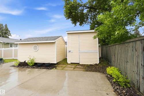 Two detached storage sheds with tan siding and shingle roofs - 17303 107 Street, Edmonton, AB 