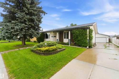 Ranch-style exterior with a detached garage and a white privacy fence - 17303 107 Street, Edmonton, AB 