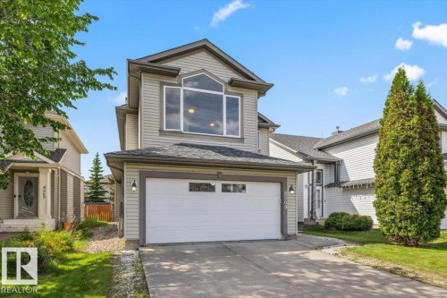 Two-story residence featuring light gray siding with dark trim accents - 8509 7 Avenue, Edmonton, AB 