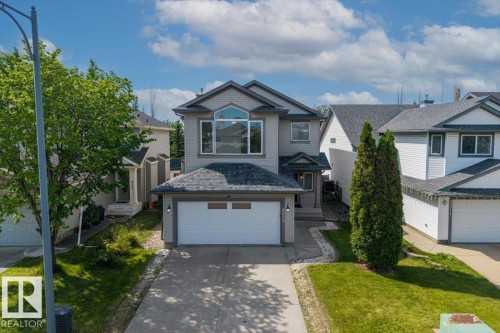 Contemporary two-story residence featuring light gray siding and dark gray trim - 8509 7 Avenue, Edmonton, AB 