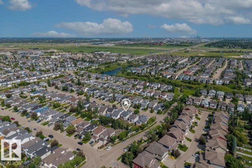 Aerial perspective showcasing a residential area with a prominent central property - 8509 7 Avenue, Edmonton, AB 