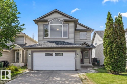 Two-story residence featuring light gray siding with dark trim accents - 8509 7 Avenue, Edmonton, AB 
