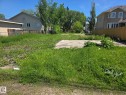 Expansive lot featuring a concrete pad and established perimeter fencing - 11726 122 Street Nw, Edmonton, AB 