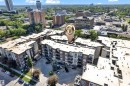 Modern multi-story apartment building featuring balconies and a surrounding urban landscape - 129 10407 122 Street, Edmonton, AB 