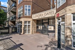 Building exterior featuring a stone facade and dark stucco, with a prominent entry gate - 
