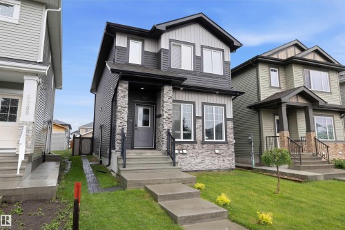 Modern two-story home featuring a combination of horizontal siding and stacked stone veneer - 6084 179 Avenue, Edmonton, AB 