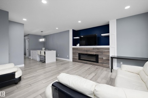 Living area featuring light wood-finish flooring and recessed lighting - 6084 179 Avenue, Edmonton, AB 