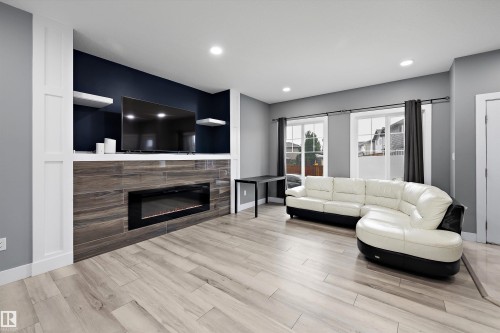 Living area featuring wood-finish flooring and recessed lighting - 6084 179 Avenue, Edmonton, AB 