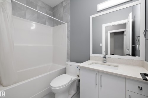 White vanity with a light-toned countertop and an integrated rectangular sink - 6084 179 Avenue, Edmonton, AB 