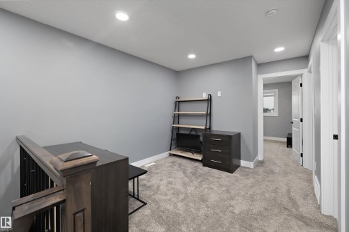 Second-floor bonus room with plush grey carpeting and grey walls - 6084 179 Avenue, Edmonton, AB 