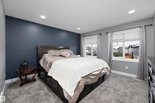 Recessed lighting and two double-hung windows with white blinds - 6084 179 Avenue, Edmonton, AB 