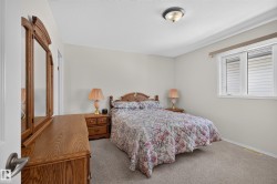 Neutral wall paint with carpet flooring, a single window, and an overhead flush mount light fixture - 
