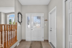 Entryway featuring a decorative glass panel door and a tiled floor - 