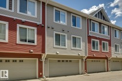 Multi-story townhome exterior featuring red and grey horizontal siding - 