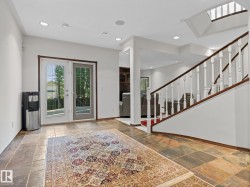 Foyer entrance featuring plenty of natural light, stairway, recessed lighting, and stone tile floors - 